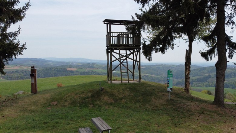 Aussichtsplattform auf einem H&uuml;gel mit Blick auf eine h&uuml;gelige Landschaft.